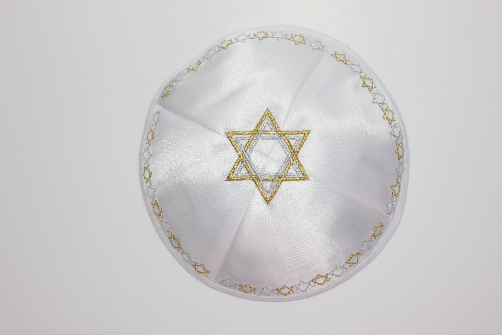 a white cloth with a gold star of david on it